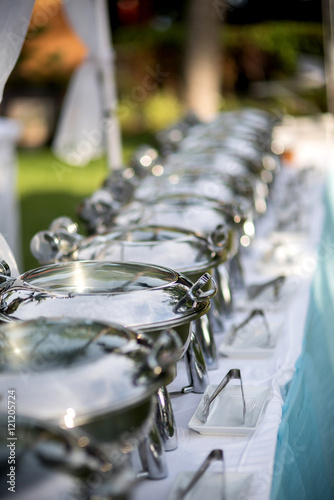 Buffet Table with Row of Food Service Steam Pans photo