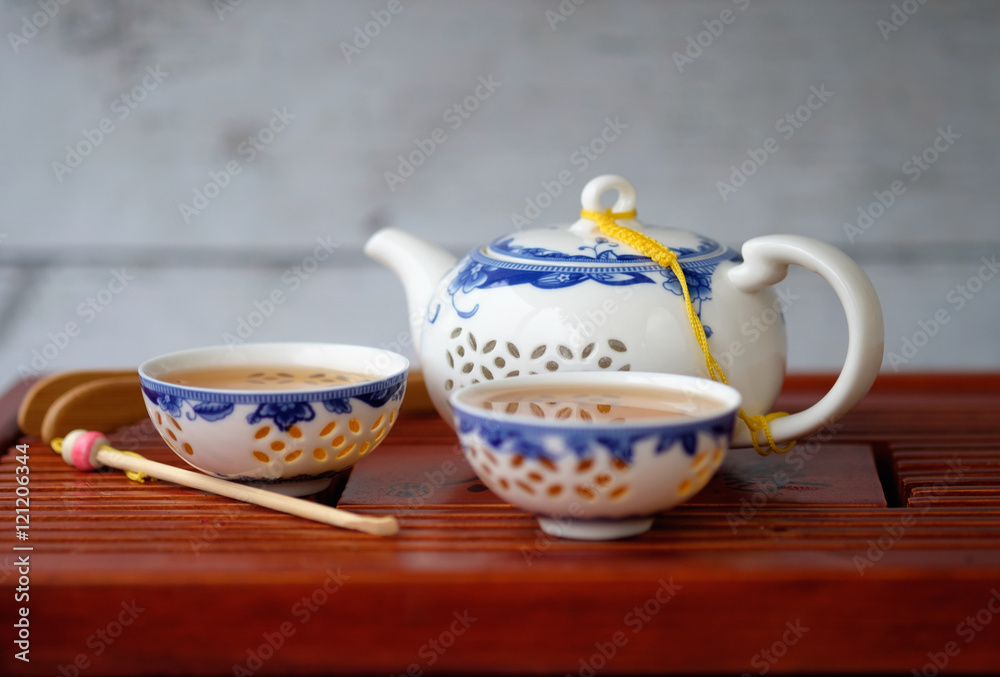 kettle and two bowls of blue and white color with green tea kettle and two bowls of blue and white color with green tea