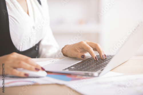 Businesswoman using laptop side