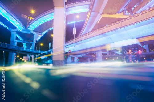  blurred traffic lights on road in central district at night.