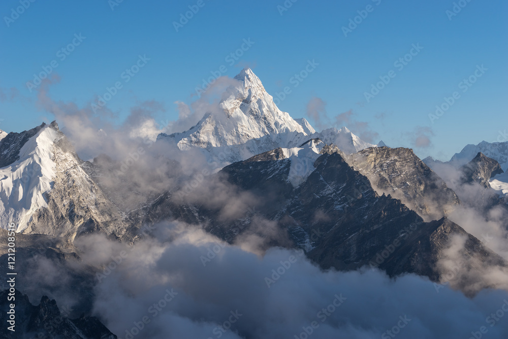 Ama Dablam mountain peak above the clouds, Everest region
