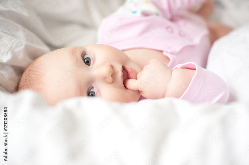 Newborn baby sucking finger and smiling Newborn baby sucking finger and smiling