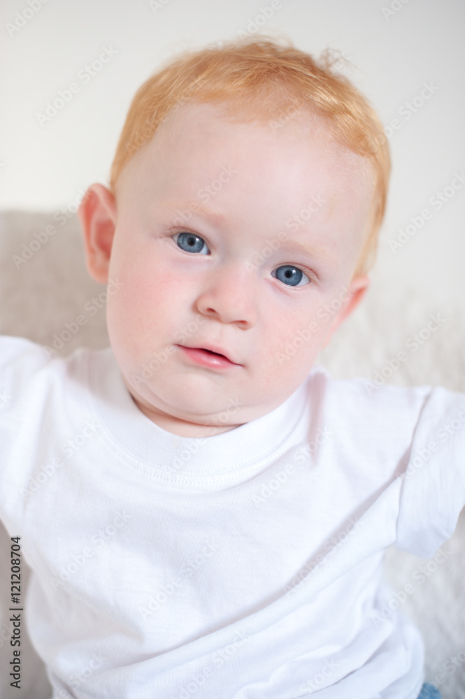 Beautiful red-haired boy with blue eyes