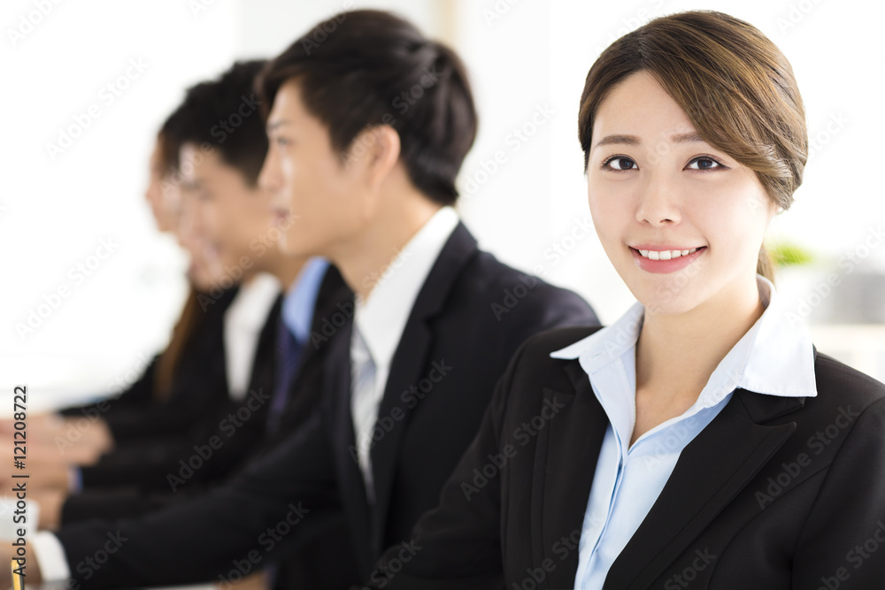 Smiling businesswoman looking at camera with colleague Smiling businesswoman looking at camera with colleague