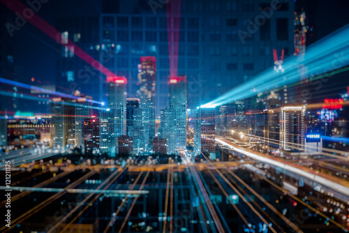 Light trails above buildings at night in China.