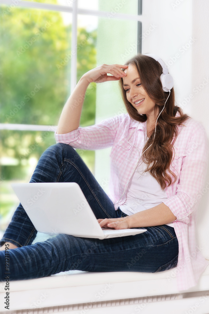 young woman in headphones with laptop young woman in headphones with laptop