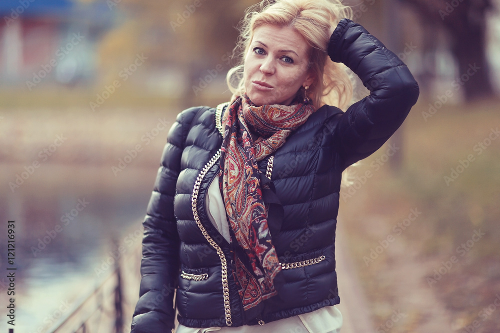 adult blond woman in autumn park