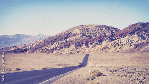 Old film stylized desert road in Death Valley, travel concept, USA.