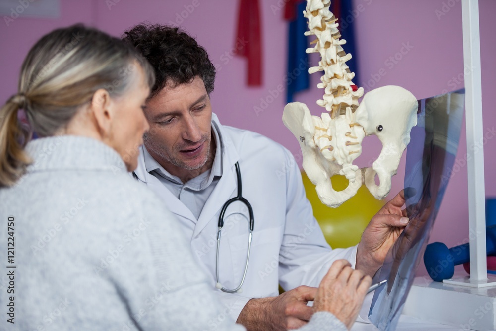 Physiotherapist explaining x-ray to patient Physiotherapist explaining x-ray to patient