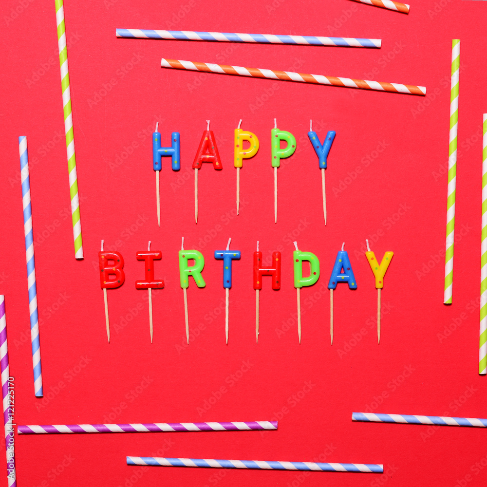 Happy Birthday flat lay party decorations on red background Happy Birthday flat lay party decorations on red background