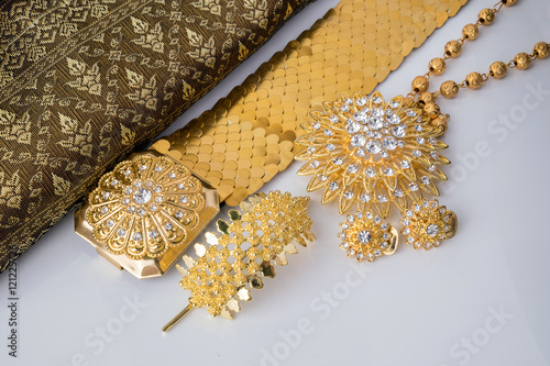 shiny gold jewelry on white background