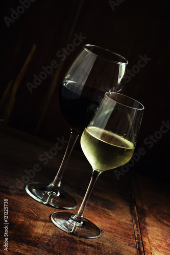 Red and white wine in glasses, dark background, low key, selecti
