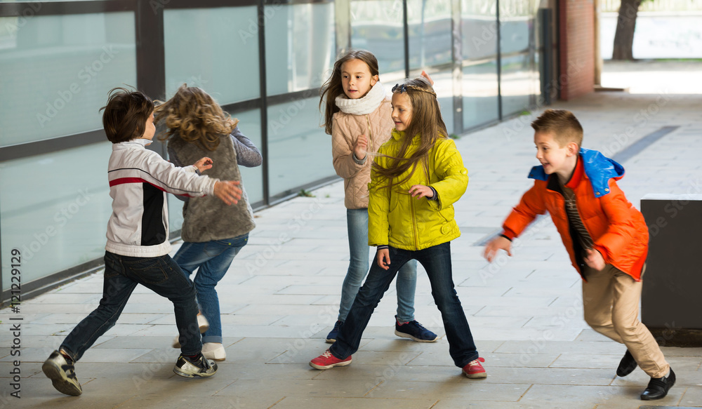 Fototapeta premium Happy kids running around while playing at tag