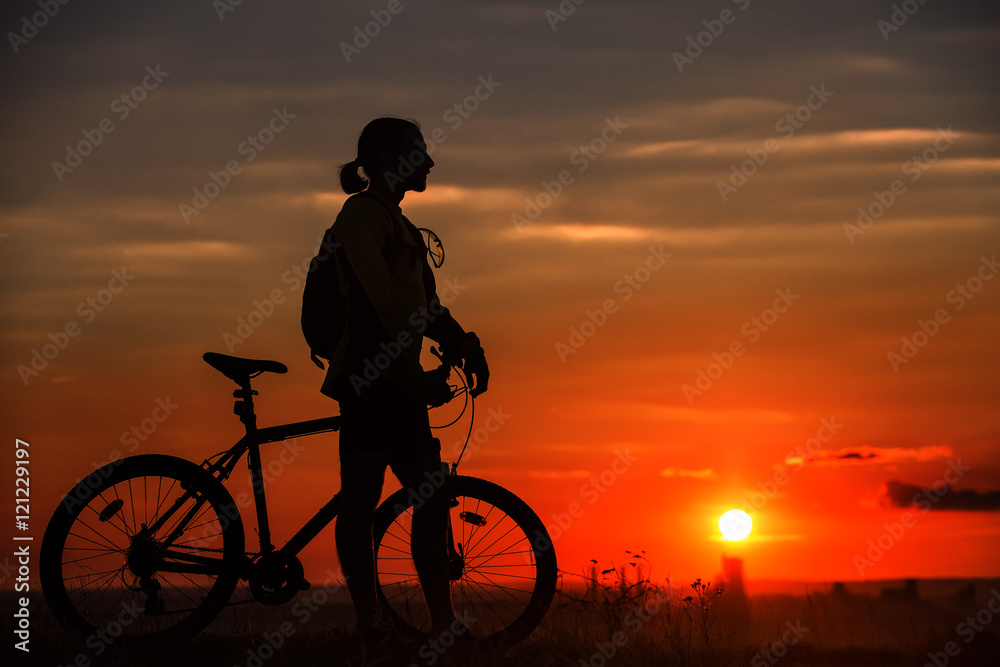 Silhouette of a bike on sky background during sunset Silhouette of a bike on sky background during sunset