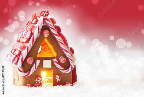Gingerbread House, Red Background With Snowflakes, Copy Space photo