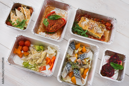 Healthy food take away in boxes, top view at wood