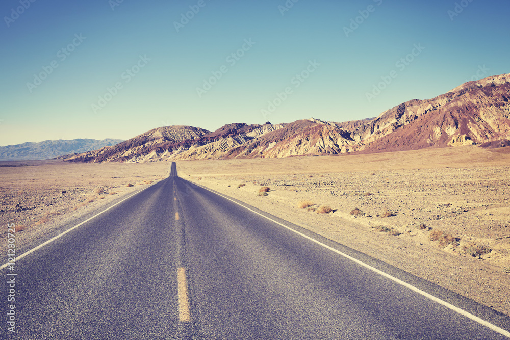 Vintage toned desert road, travel concept.