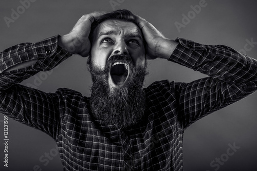 Closeup portrait of a young man screaming
