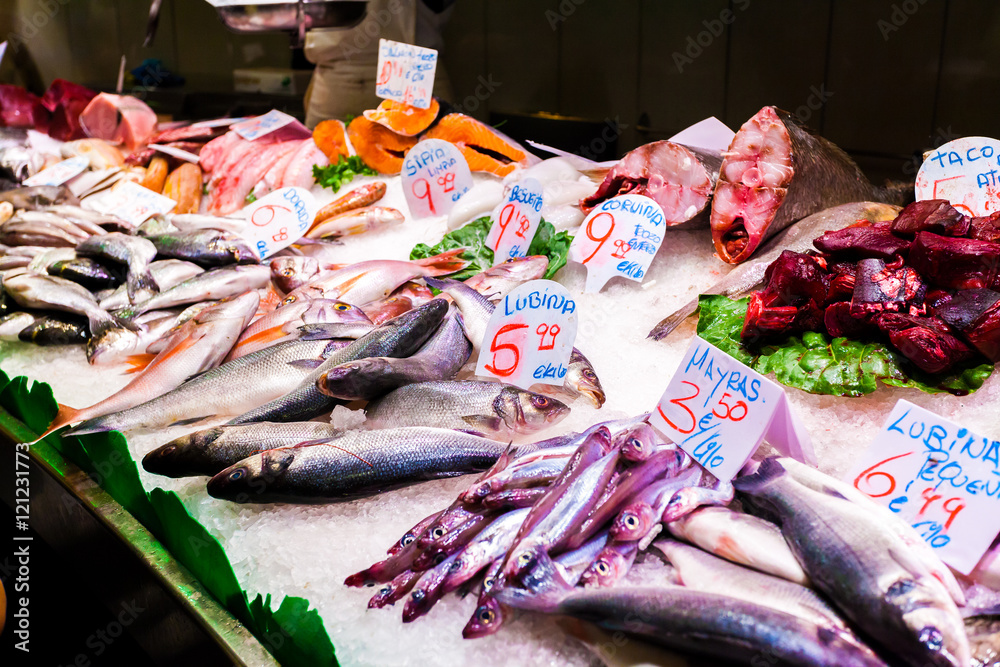 A long counter with various fish and shellfish in Boqueria market. Barcelona. A long counter with various fish and shellfish in Boqueria market. Barcelona.