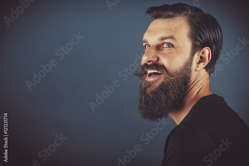Obraz na płótnie happy stylish man with beard and mustache w salonie