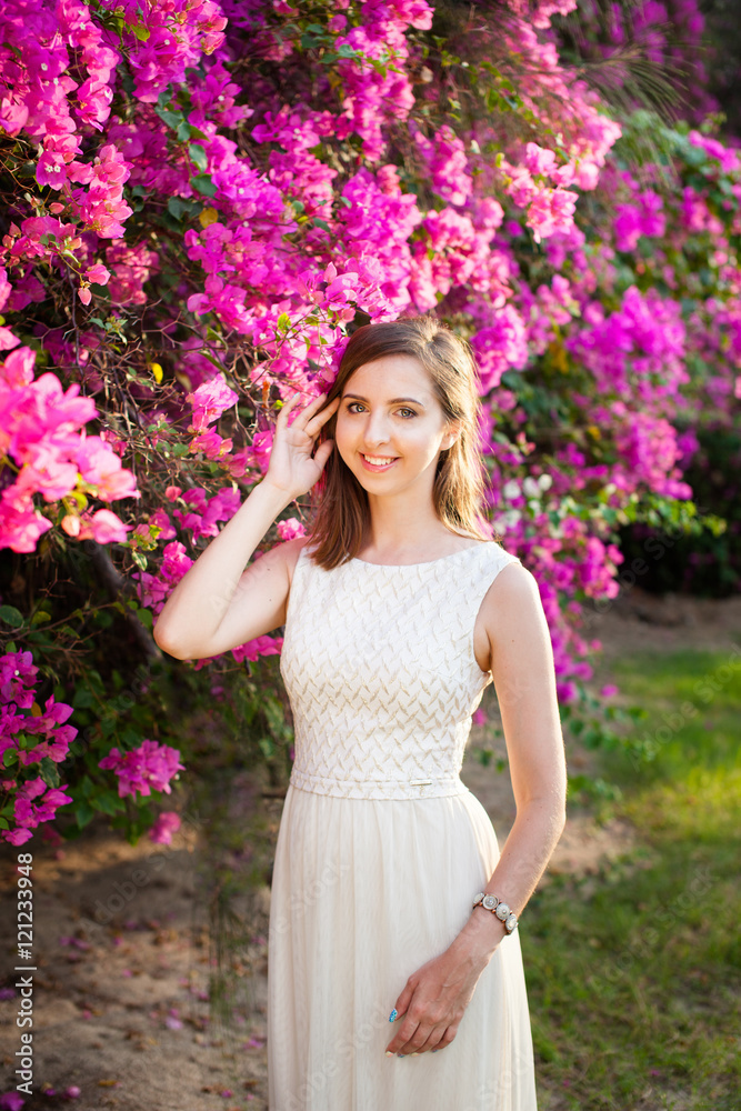 portrait of young beautiful woman girl on background of bougainvillea purple violet flowers in blossom portrait of young beautiful woman girl on background of bougainvillea purple violet flowers in blossom