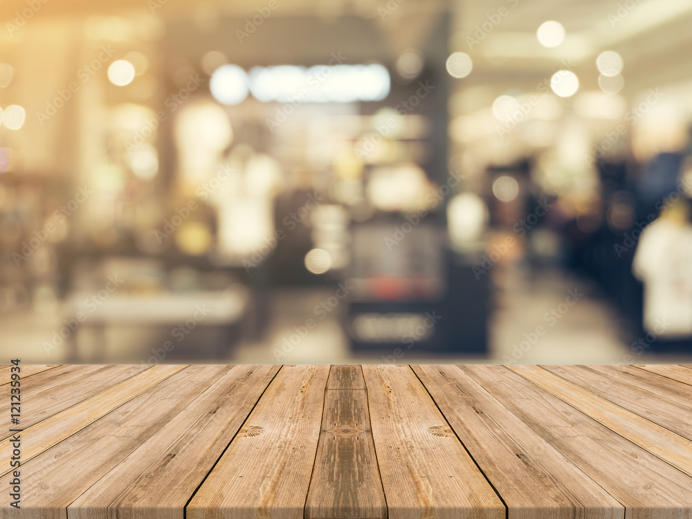 Wooden board empty table blurred background. Perspective brown wood over blur in department store - can be used for display or montage your products.Mock up for display of product. Wooden board empty table blurred background. Perspective brown wood over blur in department store - can be used for display or montage your products.Mock up for display of product.