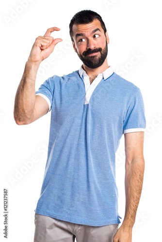 Man with blue shirt doing tiny sign