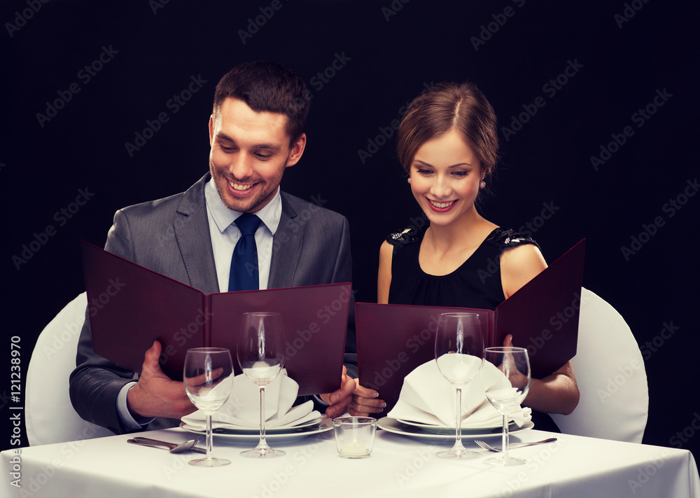 smiling couple with menus at restaurant smiling couple with menus at restaurant