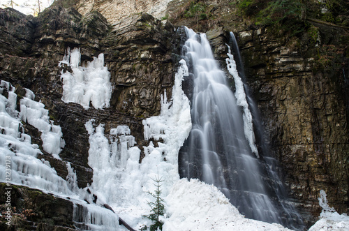 Winter view of a waterfall in the rocky canyon