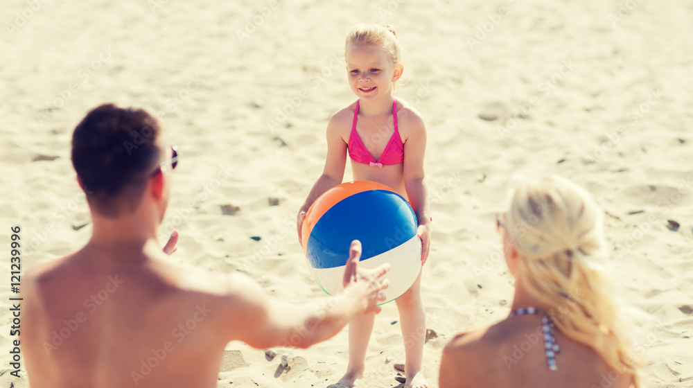 Fototapeta premium happy family playing with inflatable ball on beach