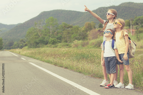 Happy children walking on the road at the day time.