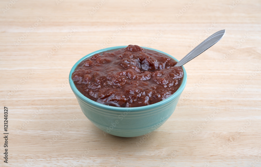 Bowl of wild strawberry preserves with spoon on a table. Bowl of wild strawberry preserves with spoon on a table.