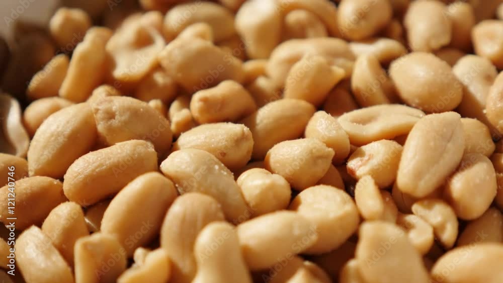 Roasted groundnut snack food slow tilting background 4K 2160p UltraHD video - Salted popular snack Arachis hypogaea peanuts pile 4K 3840X2160 UHD tilt footage Roasted groundnut snack food slow tilting background 4K 2160p UltraHD video - Salted popular snack Arachis hypogaea peanuts pile 4K 3840X2160 UHD tilt footage