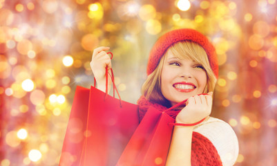 happy woman in winter clothes with shopping bags