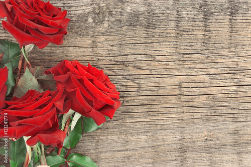 Bouquet of red roses on rustic wooden background