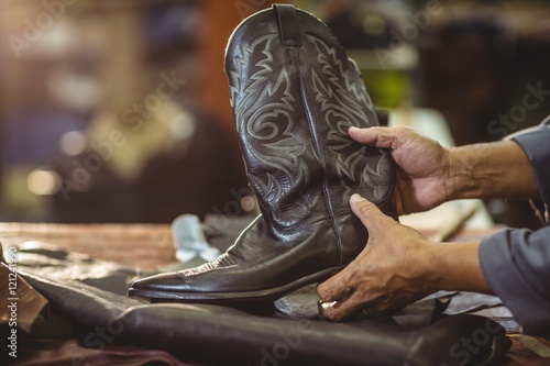 Shoemaker holding a leather boot © WavebreakmediaMicro