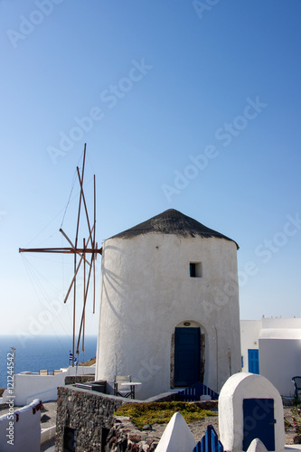 White old mills  in the town of Oia on Santorini island in Greece