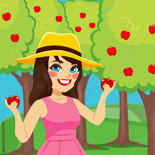 Happy woman harvesting appl...