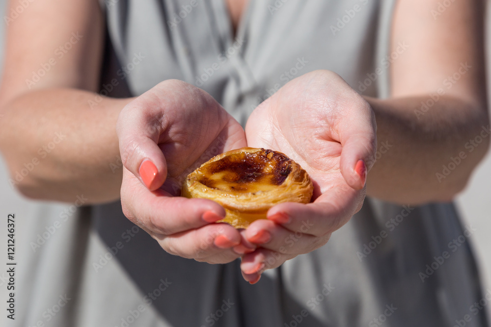 Portuguese dessert Pasteis de nata in women hand Portuguese dessert Pasteis de nata in women hand