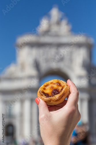 Portuguese dessert Pasteis de nata in women hand