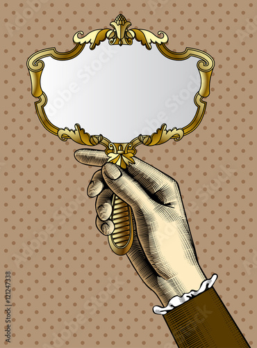 Woman's hand with a gold retro mirror