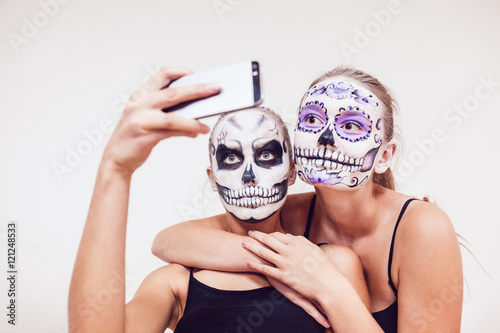 Two girls going on Halloween, grimace and make selfie