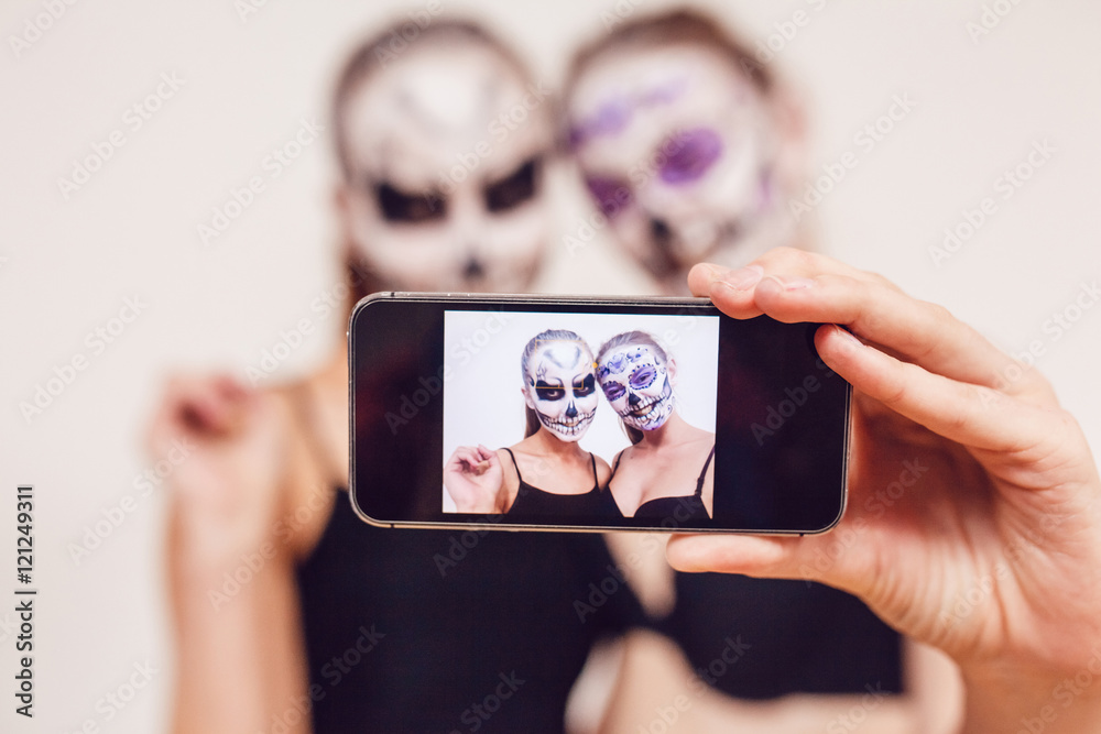 Two girls going on Halloween, grimace and make selfie