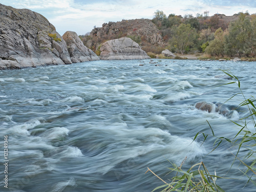 Fast flowing rapids of the Southern Buh (Yuzhny Bug) River and granite rocks in the Buzkyi Hard (Buzhsky Gard) Nature Reserve, Buh Granite-Steppe Lands, Ukraine (taken with a slow shutter speed)