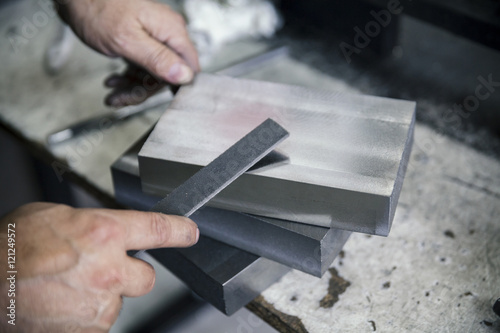 filing metals with hands photo