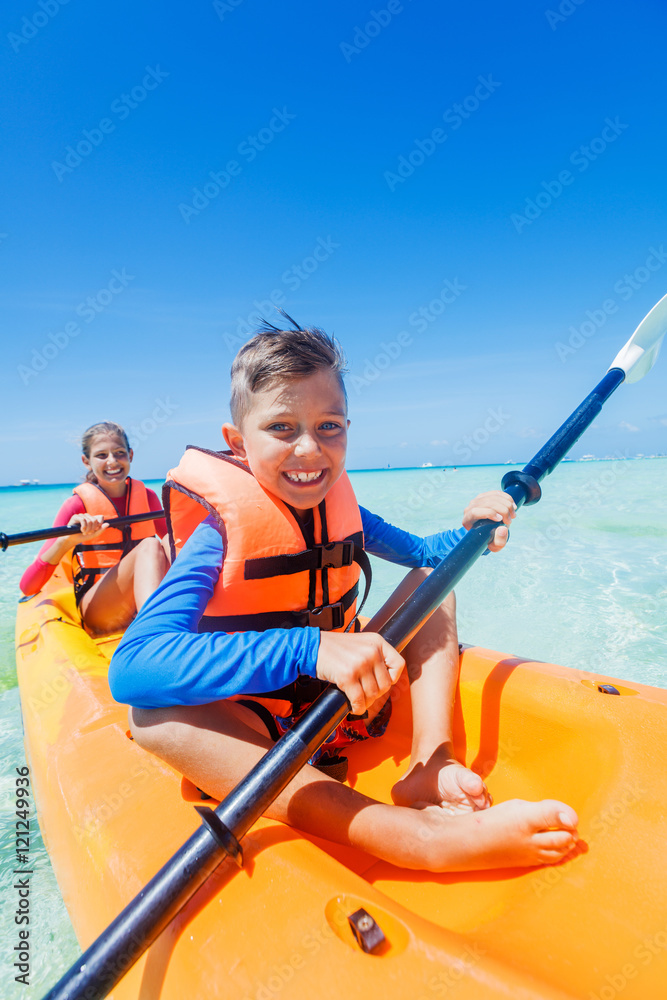 Kids paddling in kayak