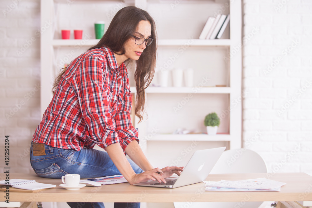 Young woman on table using laptop Young woman on table using laptop
