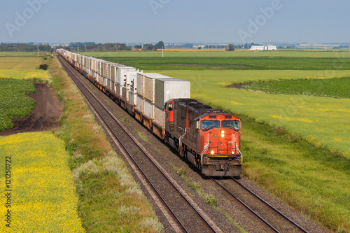 Container train across green and yellow prairie