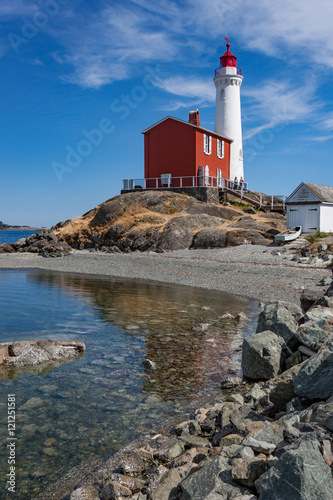 White Lighthouse on Rock Strewn Beach