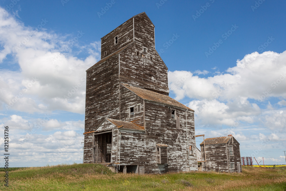 Old Weathered Grain Elevator with Blue Sky and Clouds